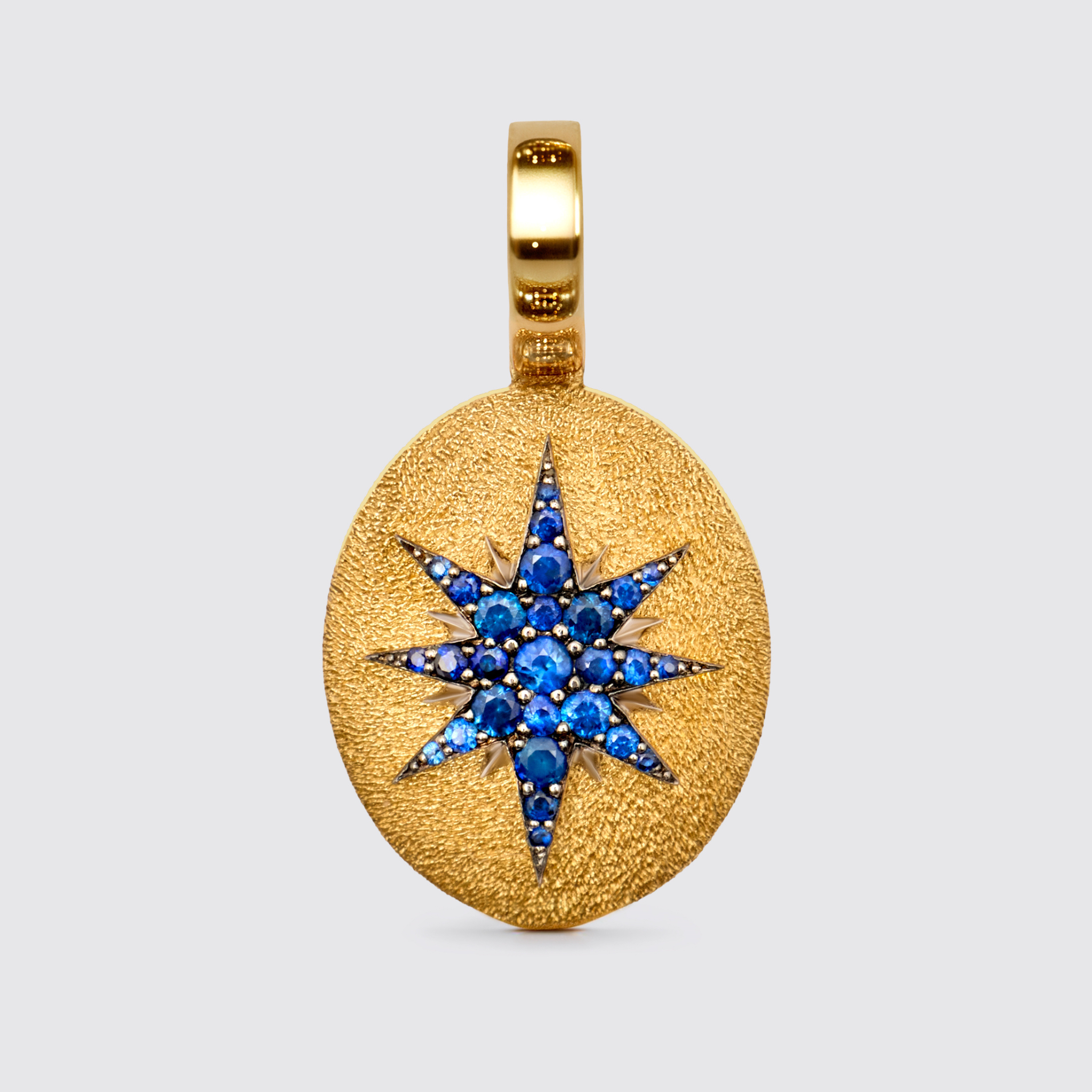 Crush Stella oval pendant, 18k yellow gold with blue sapphires, celestial star design, luxury fine jewelry