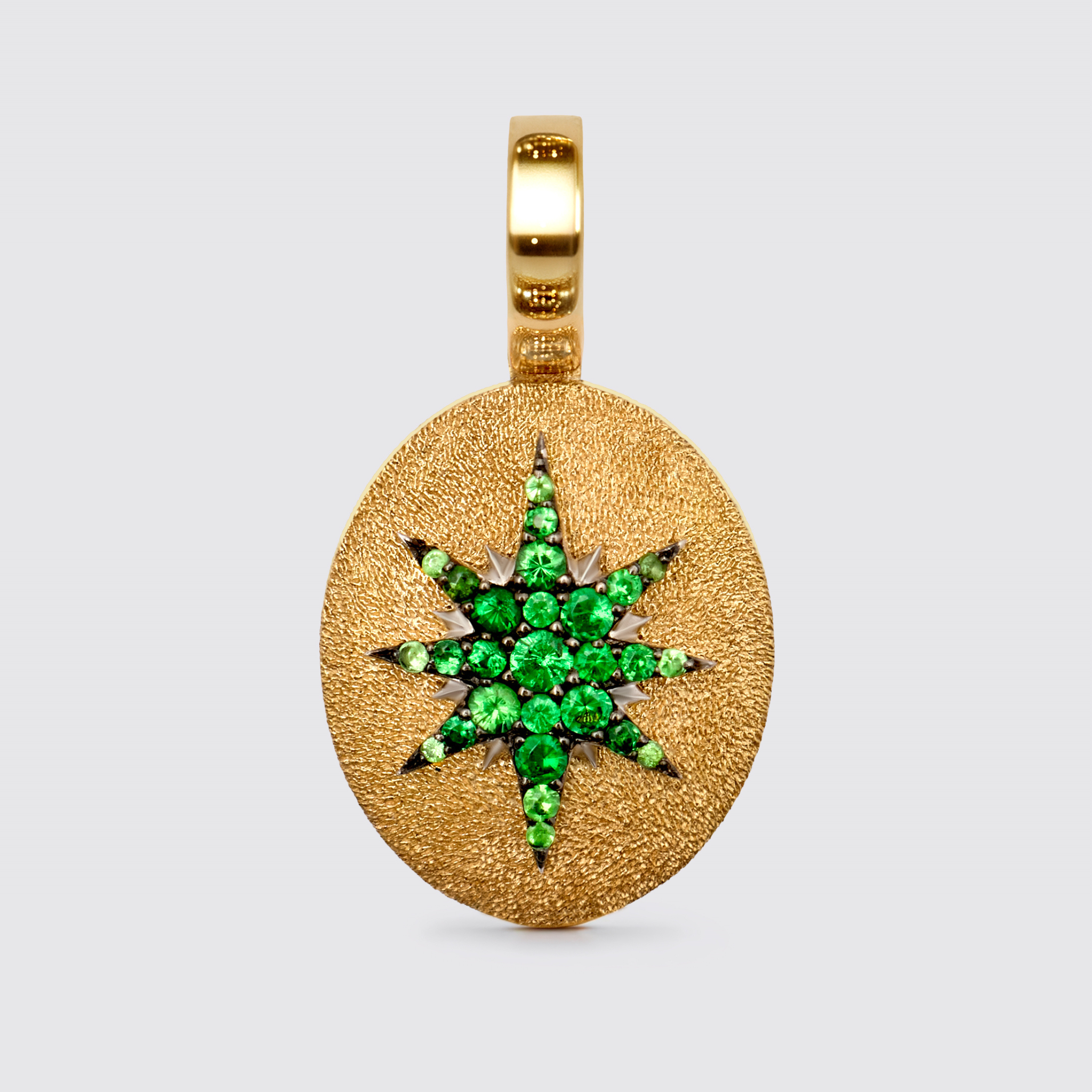Crush Stella pendant oval tsavorite gemstone star design 18k yellow gold with stardust texture luxury fine jewelry